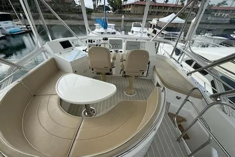 Slide: The Image of 2021 Mikelson Gen II 43 SF yacht cockpit with helm, seating, and marina view. - 12