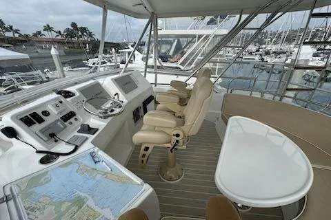 Slide: The Image of 2021 Mikelson Gen II 43 SF yacht helm with dual seats, navigation equipment, and marina view. - 14