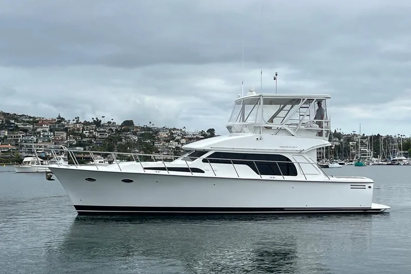 Slide: The Image of 2021 Mikelson Gen II 43 SF yacht on calm water with coastal backdrop. - 3