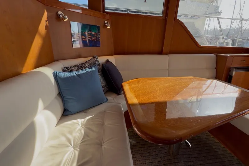 Slide: The Image of Luxurious interior of 2021 Mikelson Gen II 43 SF yacht with plush seating and wooden table. - 8