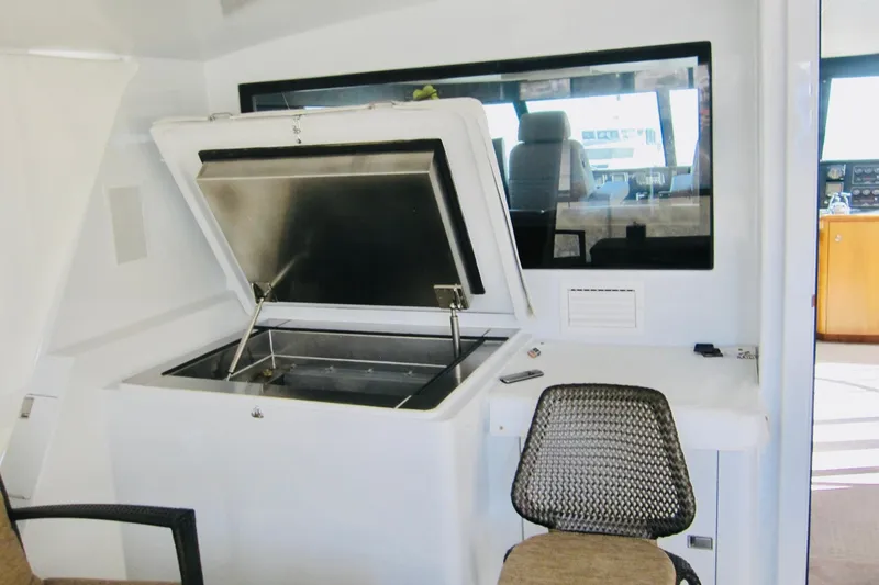 Slide: The Image of Interior of 1999 Delta Marine Raised Pilothouse Motoryacht with open storage compartment. - 19
