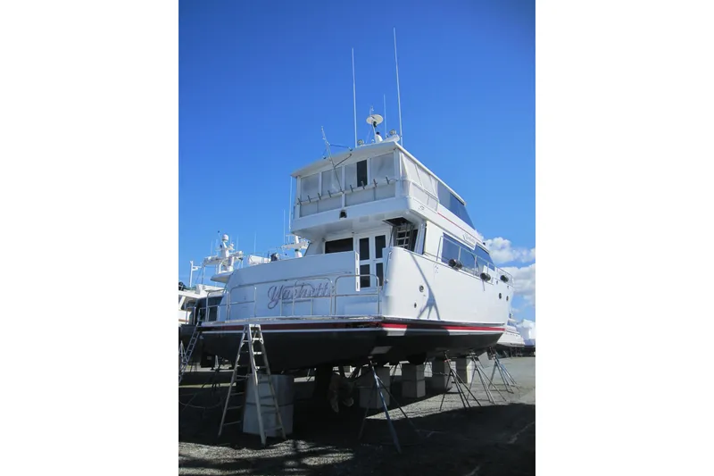 Slide: The Image of 1999 Delta Marine Raised Pilothouse Motoryacht on dry dock under clear blue sky. - 2