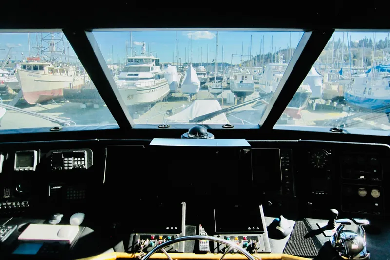 Slide: The Image of Pilothouse view from 1999 Delta Marine Raised Pilothouse Motoryacht, overlooking marina with docked boats. - 21