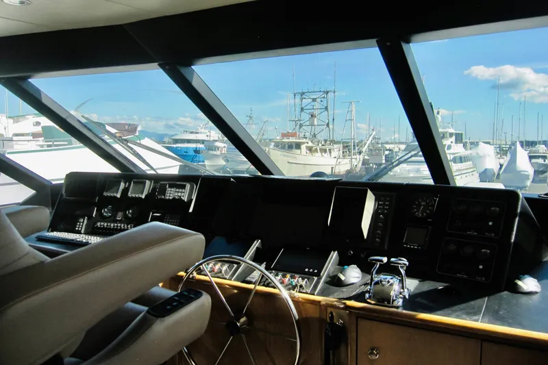 Slide: The Image of Raised pilothouse interior of 1999 Delta Marine motoryacht, overlooking marina with boats. - 22