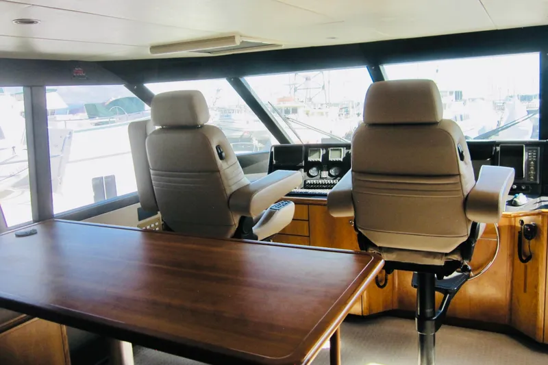Slide: The Image of Pilothouse interior of 1999 Delta Marine Raised Pilothouse Motoryacht with helm chairs and controls. - 23
