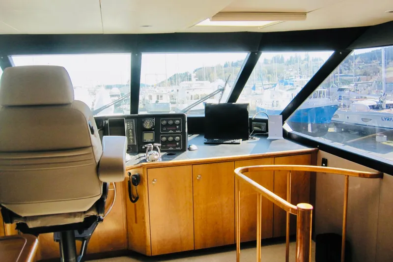 Slide: The Image of Raised pilothouse interior of 1999 Delta Marine Motoryacht, featuring helm and navigation equipment. - 26