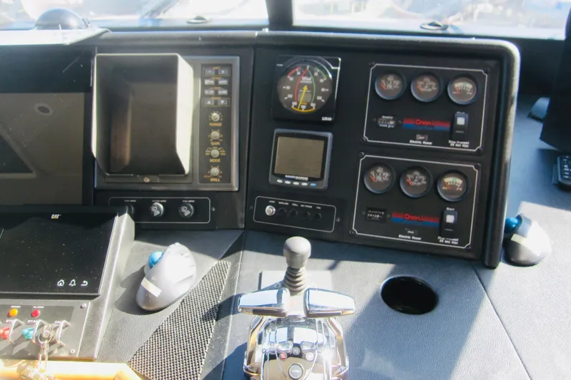 Slide: The Image of Control panel of a 1999 Delta Marine Raised Pilothouse Motoryacht, featuring gauges and switches. - 28