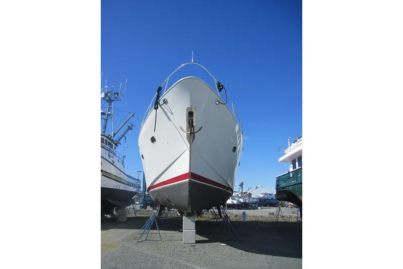 Slide: The Image of Delta Marine 1999 Raised Pilothouse Motoryacht on dry dock under clear blue sky. - 3