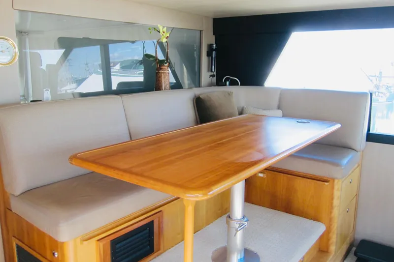 Slide: The Image of Luxurious interior of 1999 Delta Marine Raised Pilothouse Motoryacht with elegant wooden table and seating. - 32