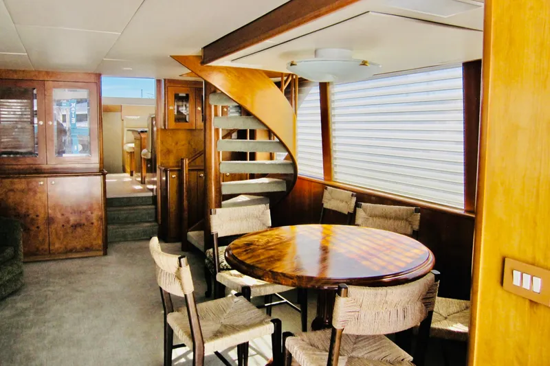 Slide: The Image of Luxurious interior of 1999 Delta Marine Raised Pilothouse Motoryacht with dining area and spiral staircase. - 38