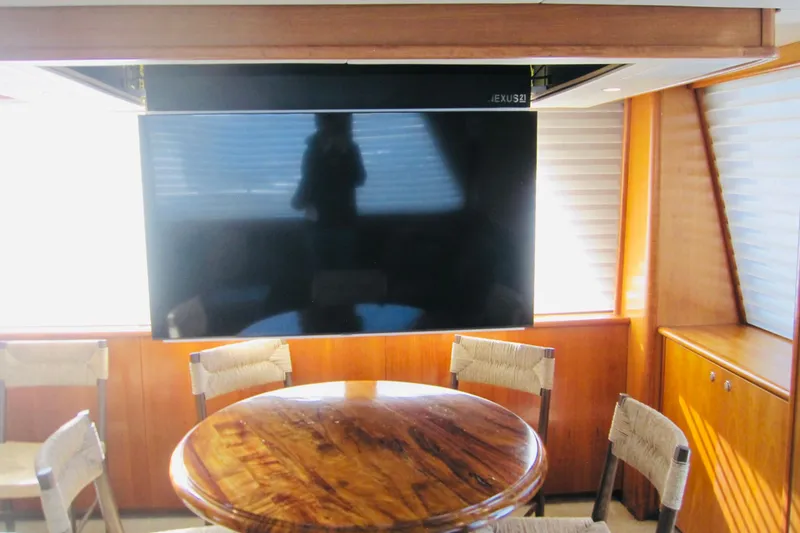 Slide: The Image of Luxurious interior of 1999 Delta Marine Raised Pilothouse Motoryacht with TV and wooden table. - 39