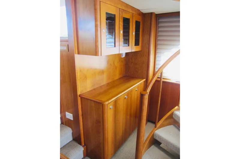 Slide: The Image of Luxurious wooden interior of 1999 Delta Marine Raised Pilothouse Motoryacht with elegant cabinetry and staircase. - 44