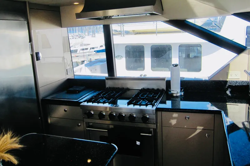 Slide: The Image of Luxurious kitchen interior of 1999 Delta Marine Raised Pilothouse Motoryacht with modern appliances. - 51