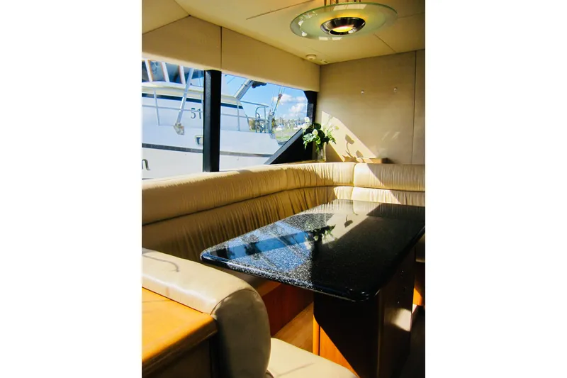 Slide: The Image of Luxurious interior of 1999 Delta Marine Raised Pilothouse Motoryacht with elegant seating and table. - 54