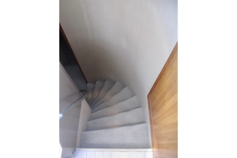Slide: The Image of Curved staircase inside 1999 Delta Marine Raised Pilothouse Motoryacht. - 56