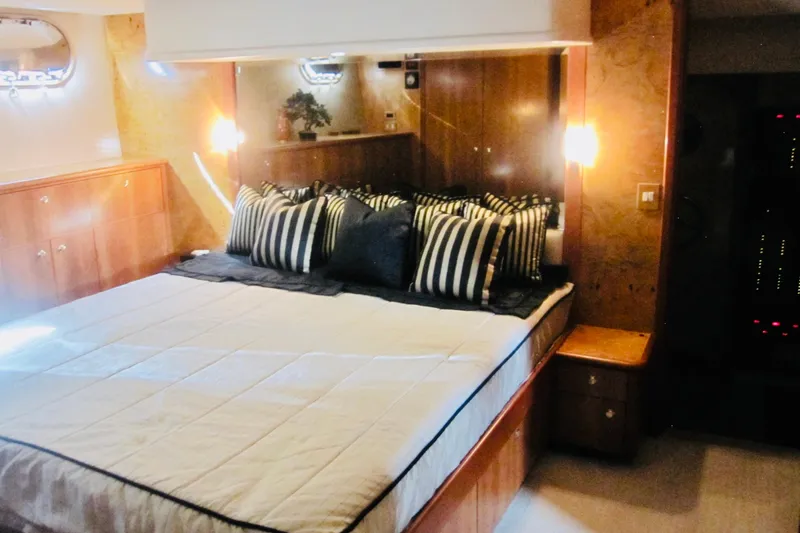 Slide: The Image of Luxurious bedroom interior of 1999 Delta Marine Raised Pilothouse Motoryacht with striped pillows. - 58