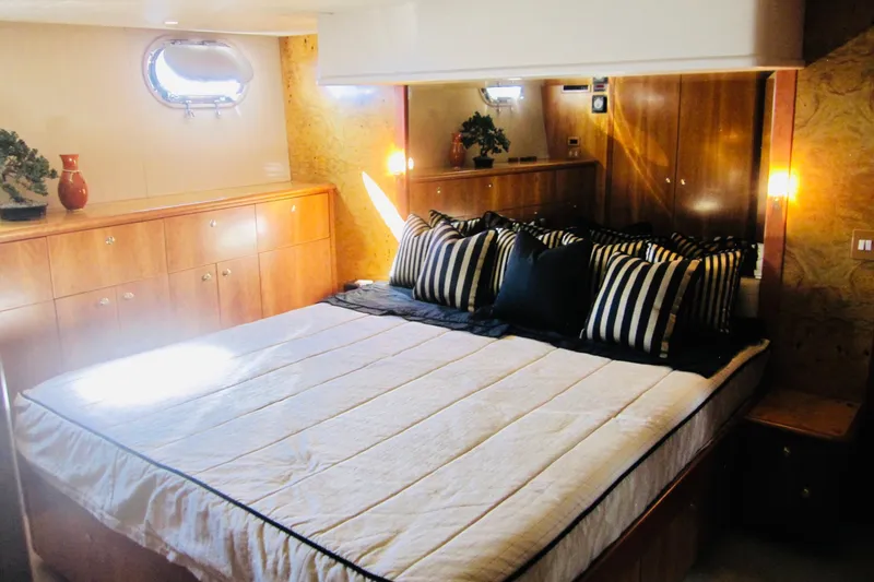 Slide: The Image of Luxurious bedroom interior of 1999 Delta Marine Raised Pilothouse Motoryacht with striped pillows. - 60