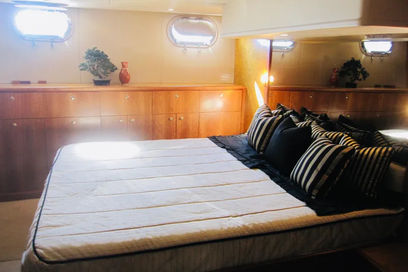 Slide: The Image of Luxurious bedroom interior of 1999 Delta Marine Raised Pilothouse Motoryacht with striped pillows. - 61