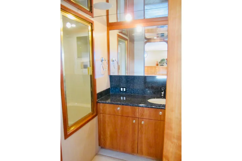 Slide: The Image of Luxurious bathroom in 1999 Delta Marine Raised Pilothouse Motoryacht with granite countertop and wood cabinetry. - 65