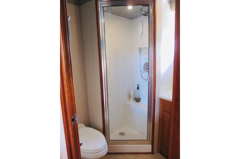 Slide: The Image of Bathroom with shower and toilet on 1999 Delta Marine Raised Pilothouse Motoryacht. - 74