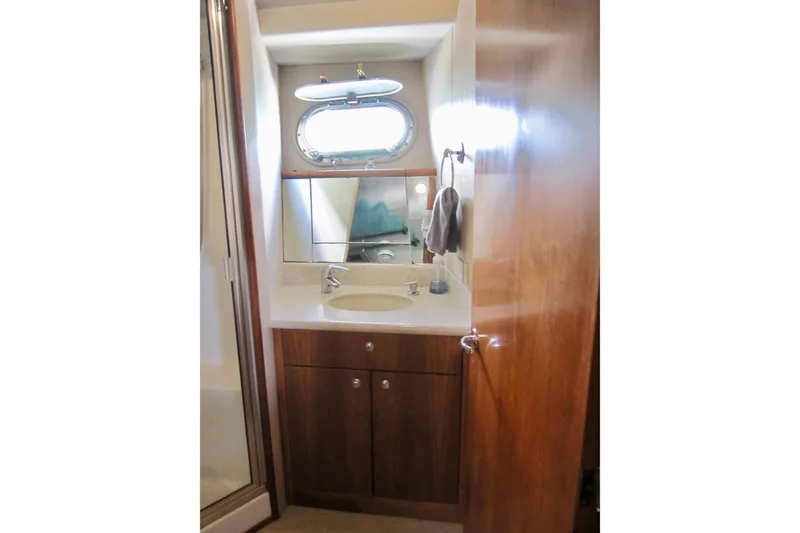 Slide: The Image of Bathroom interior of 1999 Delta Marine Raised Pilothouse Motoryacht with wooden cabinetry. - 75