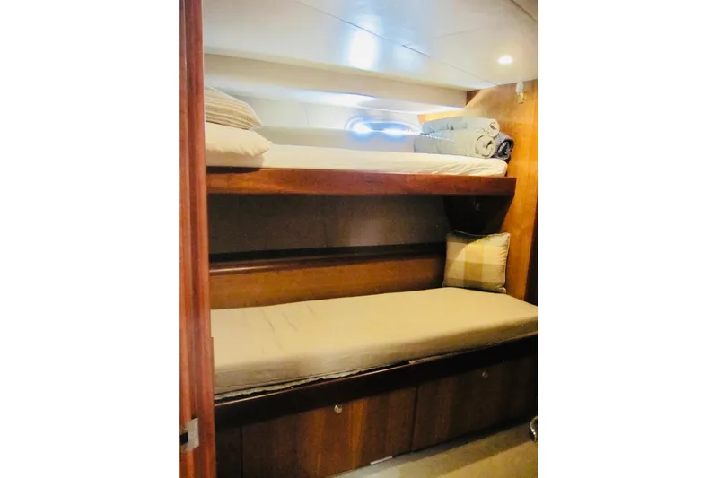 Slide: The Image of Bunk beds in 1999 Delta Marine Raised Pilothouse Motoryacht cabin, featuring wooden interior. - 76
