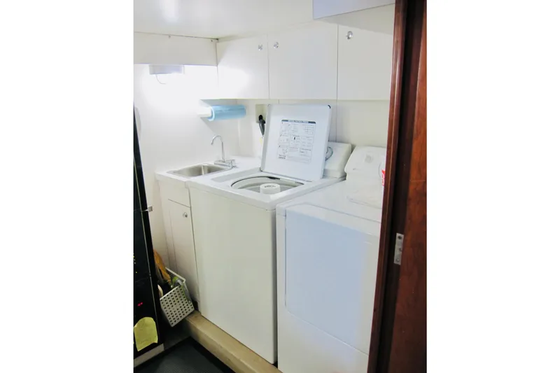 Slide: The Image of Laundry area in 1999 Delta Marine Raised Pilothouse Motoryacht with washer, dryer, and sink. - 78