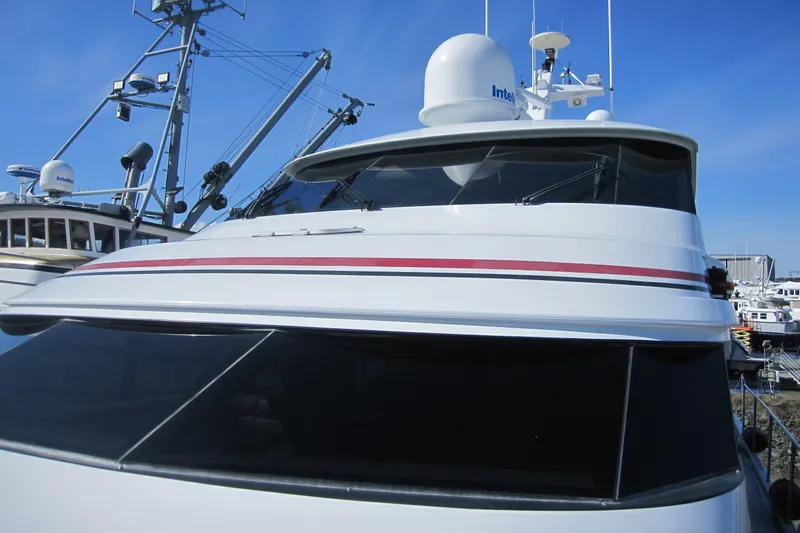 Slide: The Image of 1999 Delta Marine Raised Pilothouse Motoryacht with radar equipment, docked under clear blue sky. - 8