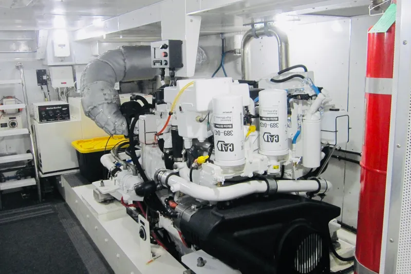 Slide: The Image of Engine room of a 1999 Delta Marine Raised Pilothouse Motoryacht, featuring mechanical equipment. - 80