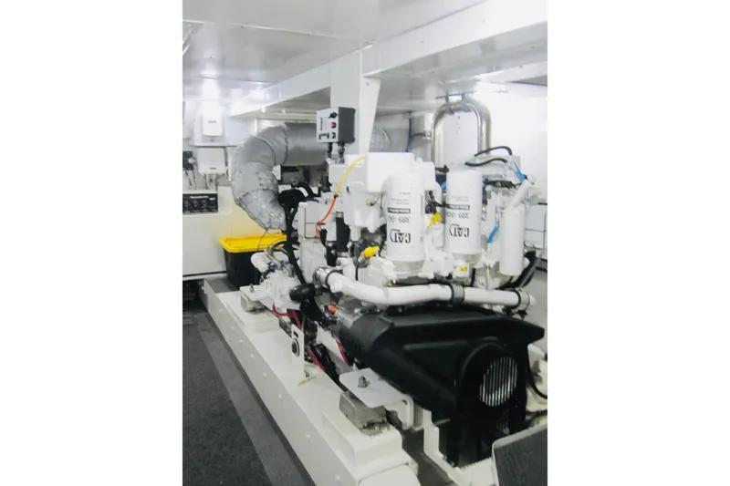 Slide: The Image of Engine room of 1999 Delta Marine Raised Pilothouse Motoryacht, showcasing mechanical components. - 82