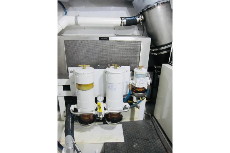 Slide: The Image of Engine room of 1999 Delta Marine Raised Pilothouse Motoryacht with fuel filters and piping. - 87