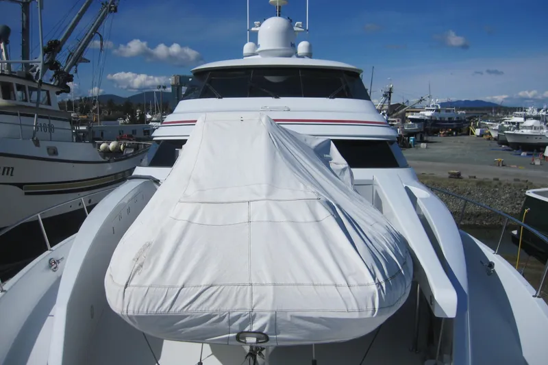 Slide: The Image of 1999 Delta Marine Raised Pilothouse Motoryacht docked, featuring covered equipment on deck. - 9