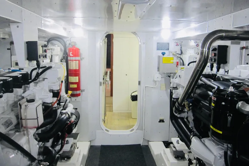 Slide: The Image of Engine room of 1999 Delta Marine Raised Pilothouse Motoryacht, featuring machinery and fire extinguisher. - 90