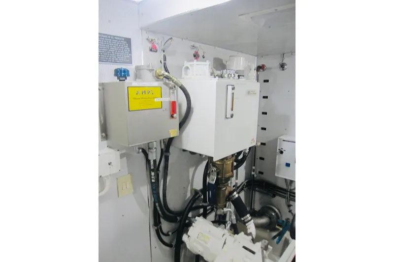 Slide: The Image of Engine room of 1999 Delta Marine Raised Pilothouse Motoryacht, featuring mechanical equipment and piping. - 92