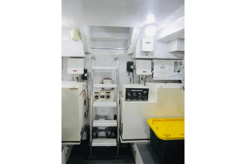 Slide: The Image of Engine room of 1999 Delta Marine Raised Pilothouse Motoryacht, featuring equipment and control panels. - 93