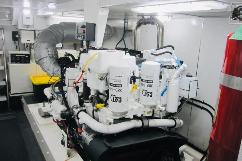 Slide: The Image of Engine room of a 1999 Delta Marine Raised Pilothouse Motoryacht, showcasing machinery and equipment. - 96