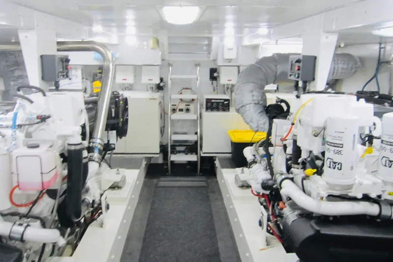 Slide: The Image of Engine room of 1999 Delta Marine Raised Pilothouse Motoryacht, featuring dual engines and equipment. - 97