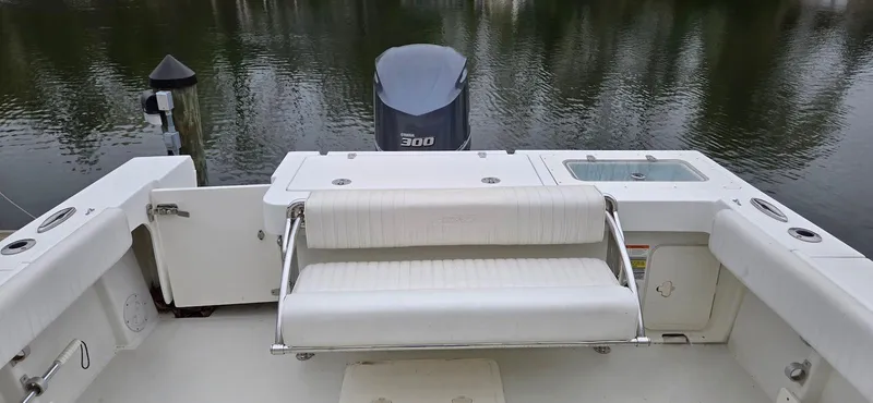 Slide: The Image of 2014 Parker 2520 XLD Sport Cabin boat with seating and outboard motor on calm water. - 9