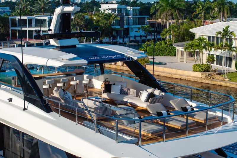 Slide: The Image of Luxurious 2024 Baglietto DOM 133 yacht with elegant outdoor seating and scenic waterfront view. - 10