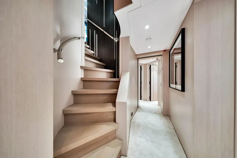 Slide: The Image of Luxurious interior of 2024 Baglietto DOM 133 yacht featuring elegant staircase and modern hallway design. - 101
