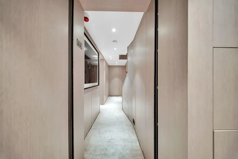 Slide: The Image of Modern interior hallway of 2024 Baglietto DOM 133 yacht, featuring sleek wood paneling. - 102