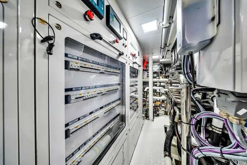 Slide: The Image of Engine room of 2024 Baglietto DOM 133 yacht, showcasing advanced control panels and wiring. - 125