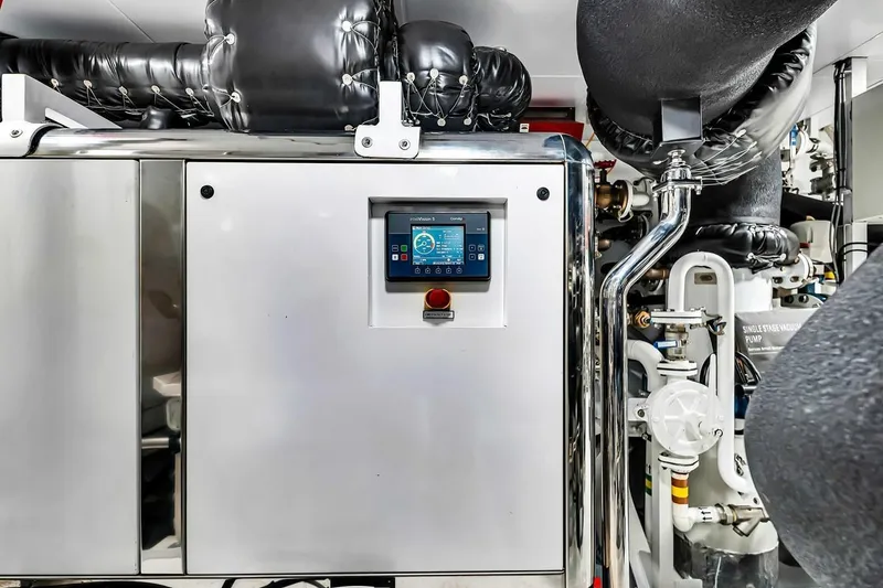 Slide: The Image of Engine room of 2024 Baglietto DOM 133 yacht with control panel and piping. - 128