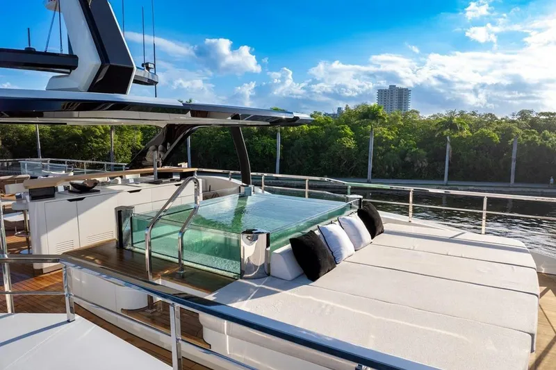 Slide: The Image of Luxurious 2024 Baglietto DOM 133 yacht with sun deck and pool, surrounded by lush greenery. - 15