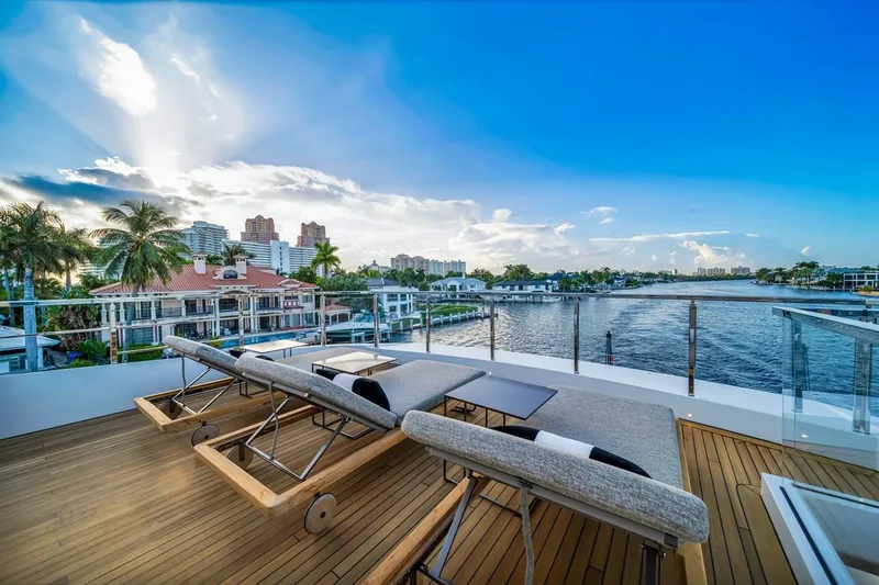 Slide: The Image of Luxurious deck view from 2024 Baglietto DOM 133 yacht overlooking waterfront homes and skyline. - 18