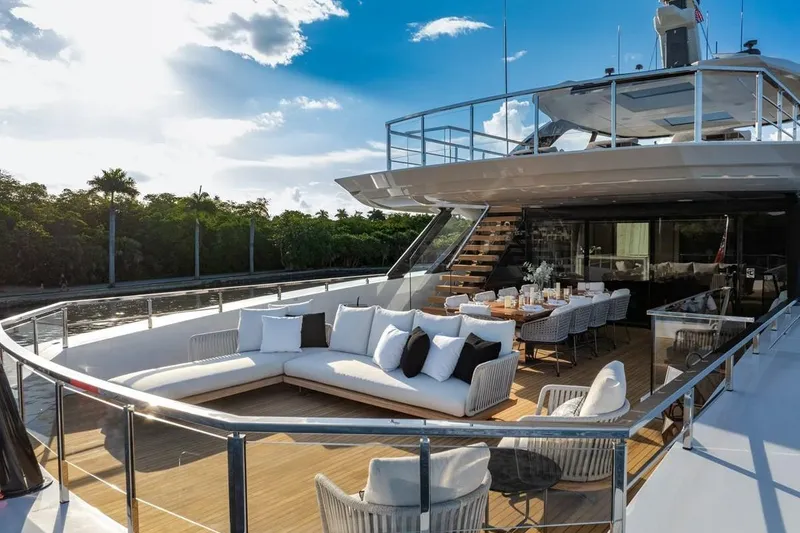 Slide: The Image of Luxurious 2024 Baglietto DOM 133 yacht with elegant outdoor seating and dining area. - 26