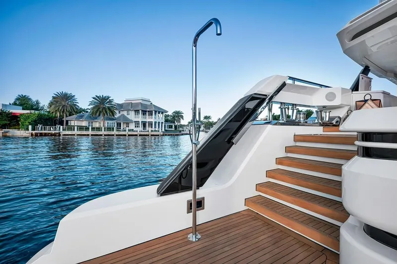 Slide: The Image of Luxurious 2024 Baglietto DOM 133 yacht with elegant wooden steps and waterfront view. - 37