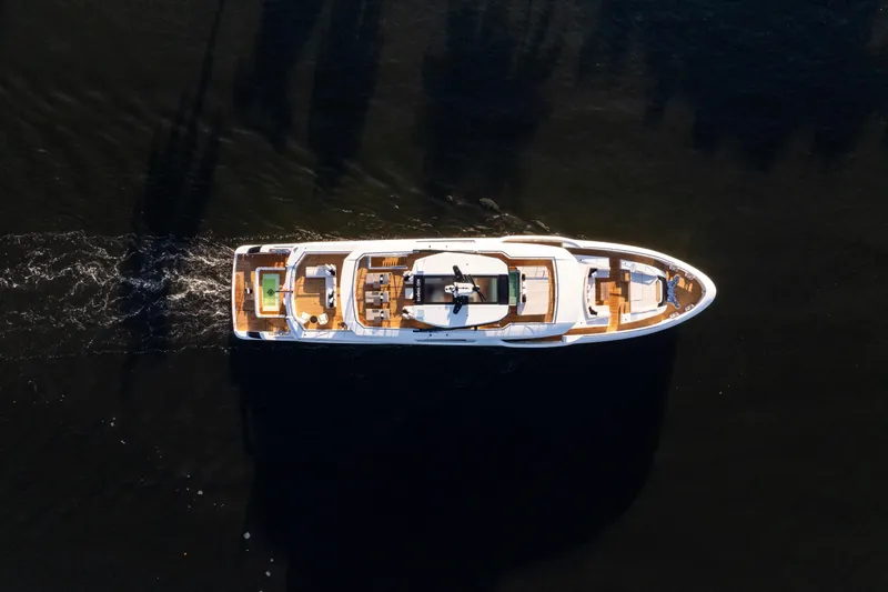 Slide: The Image of Aerial view of 2024 Baglietto DOM 133 yacht cruising on dark water. - 4