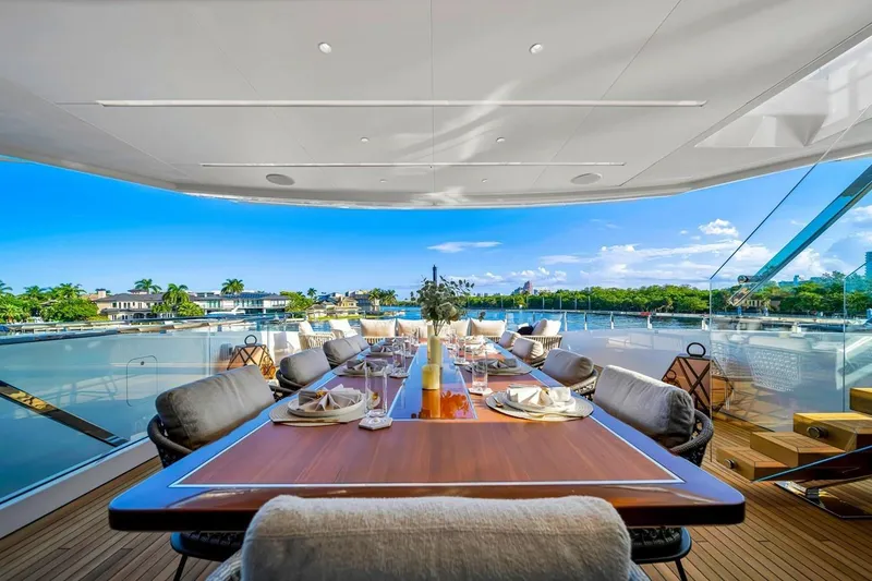 Slide: The Image of Luxurious dining area on 2024 Baglietto DOM 133 yacht with scenic waterfront view. - 44