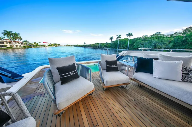 Slide: The Image of Luxurious 2024 Baglietto DOM 133 yacht deck with elegant seating and scenic waterfront view. - 51